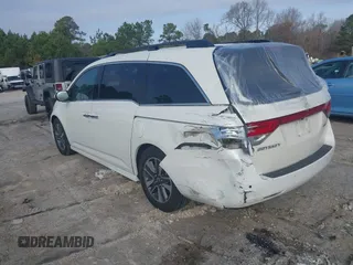 2014 Honda Odyssey Touring with VIN 5FNRL5H97EB127836, listed as a IAAI auction lot 41497413 with 174,914 mi miles and . Bid and sale history available at DreamBid. Image 3.