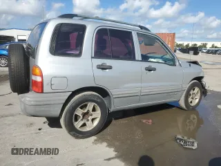 2003 Chevrolet Tracker with VIN 2CNBE13C836953178, listed as a Copart auction lot 60715605 with 128,978 mi miles and Salvage title. Bid and sale history available at DreamBid. Image 3.