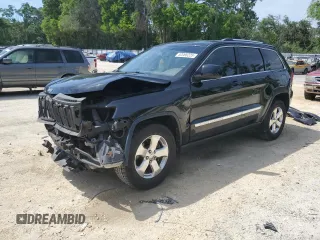 2013 Jeep Grand Cherokee Laredo with VIN 1C4RJEAG2DC519570, listed as a Copart auction lot 52066225 with 129,091 mi miles and Salvage Title. Bid and sale history available at carsss.com. Image 1.