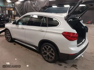 2021 BMW X1 xDrive28i with VIN WBXJG9C0XM5T76975, listed as a IAAI auction lot 41310115 with 26,869 mi miles. Bid and sale history available at carsss.com. Image 3.