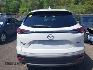 2021 Mazda CX-9 Touring z VIN JM3TCBCYXM0521323, wystawiony jako IAAI lot #42190976 z przebiegiem 56 652 mil mil oraz . Historia ofert i sprzedaży dostępna na DreamBid. Obrazek 16.