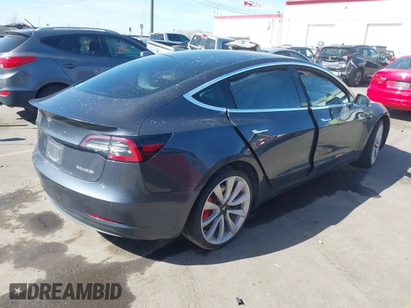 2018 Tesla Model 3 Long Range Battery with VIN 5YJ3E1EBXJF055203, listed as a IAAI auction lot 42019770 with 57,379 mi miles and . Bid and sale history available at DreamBid. Image 4.