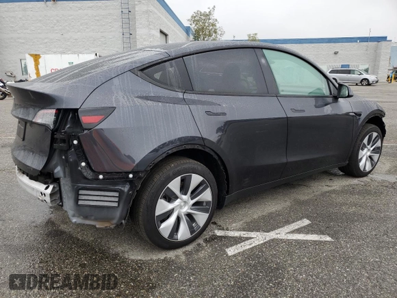 2024 Tesla Model Y with VIN 7SAYGDED5RF093410, listed as a Copart auction lot 50557225 with 6,396 mi miles and Salvage Title. Bid and sale history available at DreamBid. Image 3.