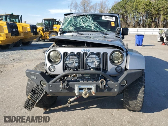 2015 Jeep Wrangler Unlimited Wrangler X with VIN 1C4BJWEG7FL580885, listed as a Copart auction lot 48891605 with 104,448 mi miles and Salvage title. Bid and sale history available at DreamBid. Image 5.