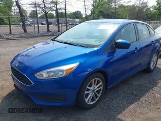 2018 Ford Focus SE z VIN 1FADP3FE1JL254632, wystawiony jako IAAI lot #42408683 z przebiegiem 74 696 mil mil oraz . Historia ofert i sprzedaży dostępna na DreamBid. Obrazek 2.