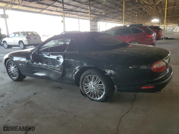 1999 Jaguar XK8 with VIN SAJGX2047XC038554, listed as a Copart auction lot 79959824 with 69,092 mi miles and Salvage Title. Bid and sale history available at carsss.com. Image 2.