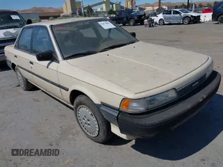 1987 Toyota Camry z VIN JT2SV21EXH3130273, wystawiony jako IAAI lot #42472806 z przebiegiem 124 958 mil mil oraz . Historia ofert i sprzedaży dostępna na DreamBid. Obrazek 1.
