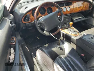 1999 Jaguar XK z VIN SAJGX2049XC034022, wystawiony jako Copart lot #55690025 z przebiegiem Nie podano mil oraz Tytuł czysty. Historia ofert i sprzedaży dostępna na DreamBid. Obrazek 8.