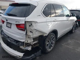 2018 BMW X5 xDrive40e iPerformance with VIN 5UXKT0C58J0V99415, listed as a IAAI auction lot 41391474 with 124,671 mi miles. Bid and sale history available at carsss.com. Image 4.