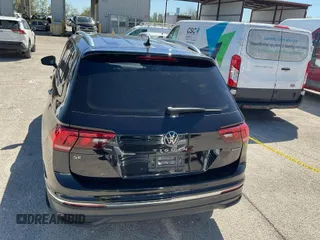 2023 Volkswagen Tiguan SE with VIN 3VV2B7AX9PM104809, listed as a IAAI auction lot 42079290 with 21,880 mi miles and . Bid and sale history available at DreamBid. Image 1.