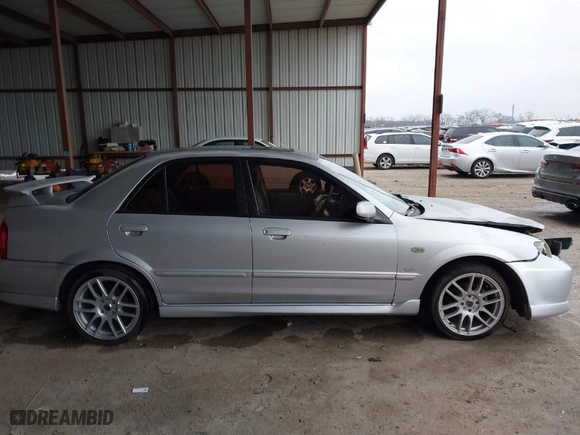 2003 Mazda Protege DX with VIN JM1BJ225030124381, listed as a IAAI auction lot 41607937 with 141,484 mi miles. Bid and sale history available at carsss.com. Image 13.