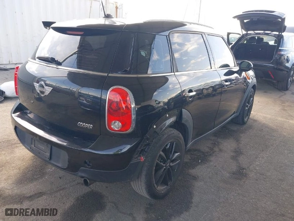 2012 MINI Cooper Countryman with VIN WMWZB3C52CWM06855, listed as a IAAI auction lot 41880609 with 59,319 mi miles. Bid and sale history available at carsss.com. Image 4.