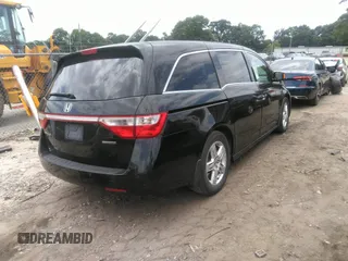 2012 Honda Odyssey Touring with VIN 5FNRL5H97CB066596, listed as a IAAI auction lot 42472935 with 217,182 mi miles and . Bid and sale history available at DreamBid. Image 4.