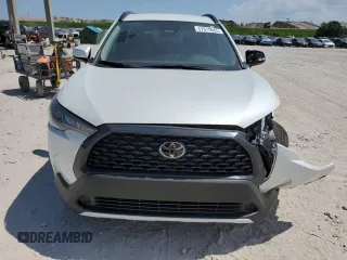2024 Toyota Corolla Cross LE with VIN 7MUCAAAG7RV090677, listed as a Copart auction lot 57615565 with 6,910 mi miles and Salvage title. Bid and sale history available at DreamBid. Image 5.