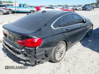 2015 BMW 4 Series 428i with VIN WBA4A5C51FG051393, listed as a IAAI auction lot 42041960 with 136,929 mi miles and . Bid and sale history available at carsss.com. Image 4.