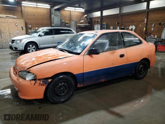 1997 Hyundai Accent z VIN KMHVD14NXVU221266, wystawiony jako Copart lot #86383044 z przebiegiem 159 517 mil mil oraz Szkoda całkowita • Salvage title. Historia ofert i sprzedaży dostępna na DreamBid. Obrazek 1.