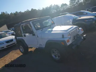 2004 Jeep Wrangler Sport Right Hand Drive with VIN 1J4F449S74P732854, listed as a IAAI auction lot 41408316 with 112,064 mi miles. Bid and sale history available at carsss.com. Image 13.