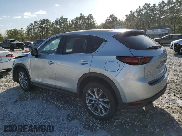2021 Mazda CX-5 Grand Touring with VIN JM3KFADM8M1339008, listed as a Copart auction lot 49150115 with 144,851 mi miles and Salvage Title. Bid and sale history available at carsss.com. Image 2.