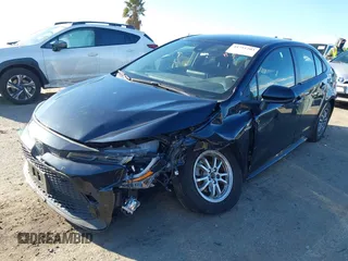 2021 Toyota Corolla Hybrid LE with VIN JTDEAMDE5MJ014959, listed as a IAAI auction lot 41751203 with 26,220 mi miles. Bid and sale history available at carsss.com. Image 2.