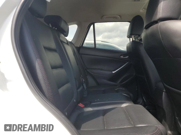 2016 Mazda CX-5 Grand Touring z VIN JM3KE2DY9G0645141, wystawiony jako Copart lot #50989635 z przebiegiem 123 898 mil mil oraz Szkoda całkowita • Salvage title. Historia ofert i sprzedaży dostępna na DreamBid. Obrazek 11.