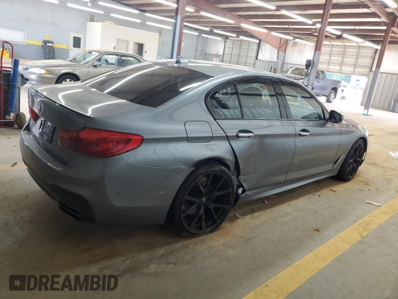 2018 BMW 5 Series M550i xDrive with VIN WBAJB9C55JB050213, listed as a Copart auction lot 61714255 with 34,700 mi miles and Salvage title. Bid and sale history available at DreamBid. Image 3.