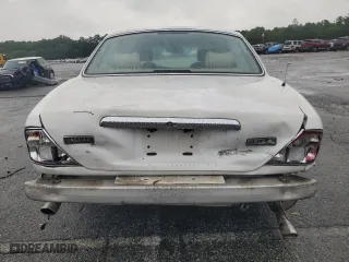 1999 Jaguar XJ with VIN SAJKX6049XC858040, listed as a Copart auction lot 64894604 with 218,054 mi miles and Salvage Title. Bid and sale history available at carsss.com. Image 6.