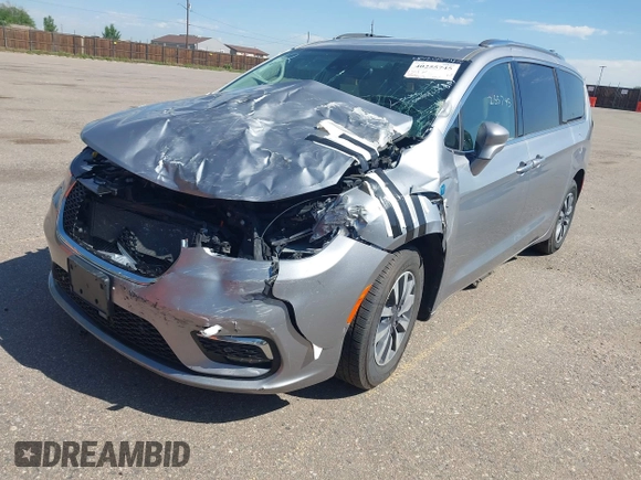 2021 Chrysler Pacifica Hybrid Touring L with VIN 2C4RC1L76MR594571, listed as a IAAI auction lot 40255745 with 58,163 mi miles and . Bid and sale history available at DreamBid. Image 18.