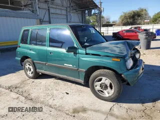 1996 Geo Tracker z VIN 2CNBE1363T6921541, wystawiony jako Copart lot #81647384 z przebiegiem 61 806 mil mil oraz Szkody całkowita. Historia ofert i sprzedaży dostępna na DreamBid. Obrazek 4.