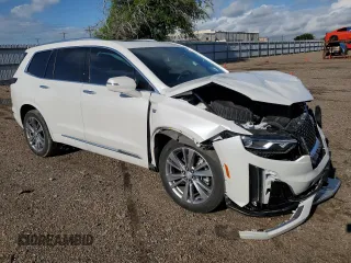 2023 Cadillac XT6 FWD Premium Luxury with VIN 1GYKPCRS5PZ120905, listed as a Copart auction lot 64374254 with 30,694 mi miles and Salvage title. Bid and sale history available at DreamBid. Image 4.
