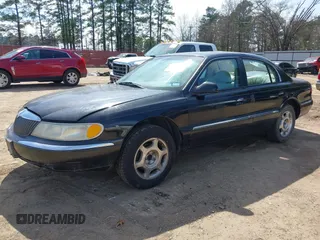 1999 Lincoln Continental with VIN 1LNHM97V8XY686521, listed as a IAAI auction lot 41681027 with 144,407 mi miles. Bid and sale history available at carsss.com. Image 2.