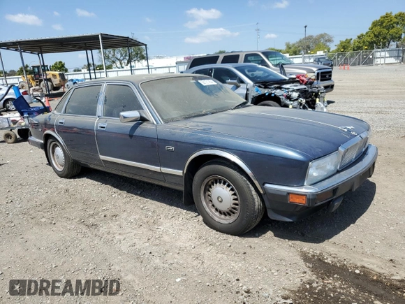 1992 Jaguar XJ with VIN SAJHY174XNC649368, listed as a Copart auction lot 50191454 with 99,553 mi miles and Salvage Title. Bid and sale history available at DreamBid. Image 4.