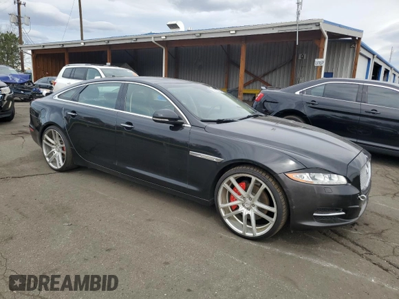 2014 Jaguar XJ Portfolio with VIN SAJWJ2GD4E8V69651, listed as a Copart auction lot 52426195 with 56,413 mi miles and Salvage title. Bid and sale history available at DreamBid. Image 4.