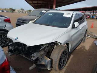 2018 BMW X1 sDrive28i with VIN WBXHU7C32J5H41587, listed as a IAAI auction lot 41538394 with 125,804 mi miles. Bid and sale history available at carsss.com. Image 2.