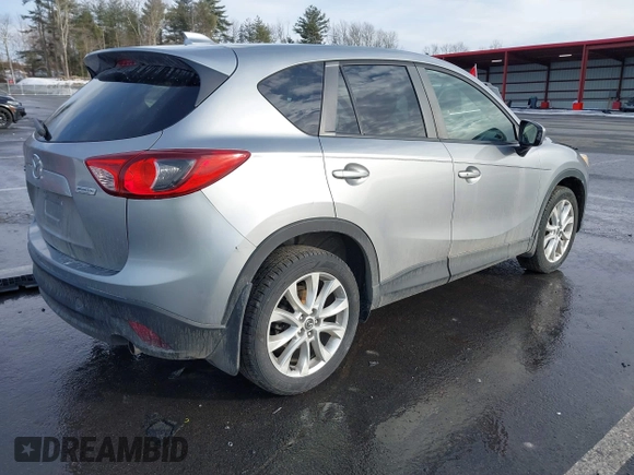 2014 Mazda CX-5 Grand Touring with VIN JM3KE2DY8E0304911, listed as a IAAI auction lot 41672197 with 77,523 mi miles. Bid and sale history available at carsss.com. Image 4.