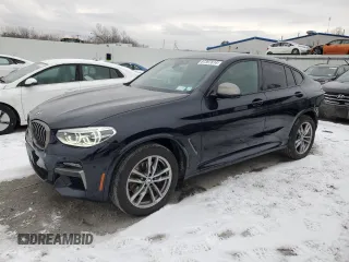 2021 BMW X4 M40i with VIN 5UX2V5C06M9F70459, listed as a Copart auction lot 87397614 with 35,233 mi miles and Salvage Title. Bid and sale history available at carsss.com. Image 1.