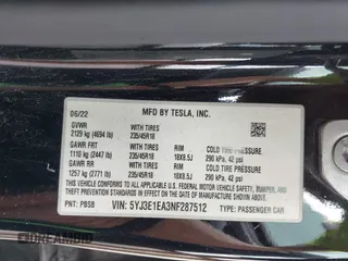 2022 Tesla Model 3 with VIN 5YJ3E1EA3NF287512, listed as a IAAI auction lot 42000557 with 77,619 mi miles. Bid and sale history available at carsss.com. Image 9.