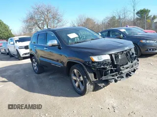 2014 Jeep Grand Cherokee Overland with VIN 1C4RJECG4EC523747, listed as a IAAI auction lot 40802143 with 124,079 mi miles. Bid and sale history available at carsss.com. Image 1.