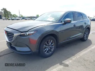 2021 Mazda CX-9 Sport with VIN JM3TCBBY7M0520437, listed as a IAAI auction lot 42022562 with 77,063 mi miles and . Bid and sale history available at DreamBid. Image 2.