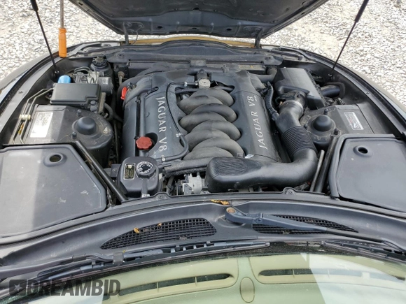 1999 Jaguar XK z VIN SAJGX2044XC031383, wystawiony jako Copart lot #54726925 z przebiegiem 107 696 mil mil oraz Szkody całkowita. Historia ofert i sprzedaży dostępna na DreamBid. Obrazek 11.