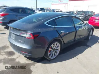 2018 Tesla Model 3 Long Range Battery with VIN 5YJ3E1EBXJF055203, listed as a IAAI auction lot 42019770 with 57,379 mi miles and . Bid and sale history available at DreamBid. Image 4.