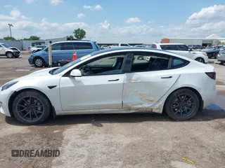 2023 Tesla Model 3 with VIN 5YJ3E1EA5PF407054, listed as a IAAI auction lot 42313770 with 57,621 mi miles and . Bid and sale history available at DreamBid. Image 6.
