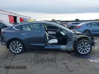 2018 Tesla Model 3 Long Range Battery with VIN 5YJ3E1EB9JF097118, listed as a IAAI auction lot 41619510 with 64,132 mi miles and . Bid and sale history available at DreamBid. Image 14.