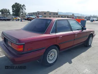 1991 Toyota Camry z VIN JT2SV21E0M3462782, wystawiony jako IAAI lot #41841451 z przebiegiem 214 611 mil mil oraz . Historia ofert i sprzedaży dostępna na DreamBid. Obrazek 4.