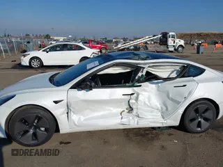 2023 Tesla Model 3 with VIN 5YJ3E1EA2PF582331, listed as a IAAI auction lot 41043858 with 33,601 mi miles and . Bid and sale history available at DreamBid. Image 6.