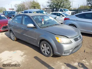 2011 Kia Rio LX with VIN KNADH4A31B6959303, listed as a IAAI auction lot 41566576 with 129,787 mi miles. Bid and sale history available at carsss.com. Image 1.
