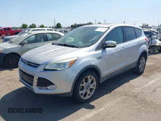 2013 Ford Escape SEL z VIN 1FMCU9H95DUC87631, wystawiony jako IAAI lot #42564756 z przebiegiem 144 467 mil mil oraz . Historia ofert i sprzedaży dostępna na DreamBid. Obrazek 2.