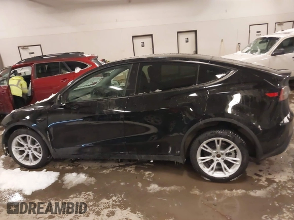 2024 Tesla Model Y Long Range with VIN 7SAYGDEEXRF085795, listed as a IAAI auction lot 41609867 with 57,049 mi miles. Bid and sale history available at carsss.com. Image 13.