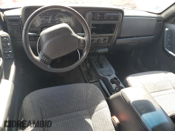1999 Jeep Cherokee Sport z VIN 1J4FF68S7XL590900, wystawiony jako Copart lot #55098635 z przebiegiem 265 588 mil mil oraz Szkoda całkowita • Salvage title. Historia ofert i sprzedaży dostępna na DreamBid. Obrazek 8.
