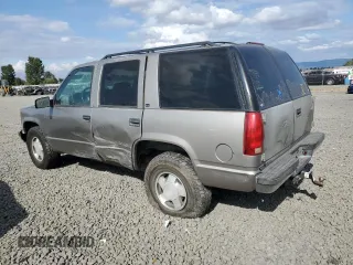 1999 GMC Yukon with VIN 1GKEK13R9XJ740395, listed as a Copart auction lot 83801394 with 185,305 mi miles and Salvage Title. Bid and sale history available at carsss.com. Image 2.