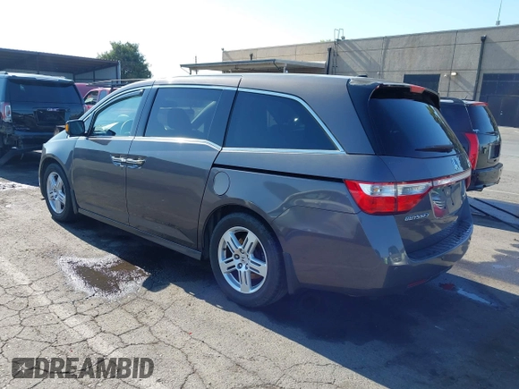 2012 Honda Odyssey Touring with VIN 5FNRL5H95CB057346, listed as a IAAI auction lot 42644094 with 114,712 mi miles and . Bid and sale history available at DreamBid. Image 3.